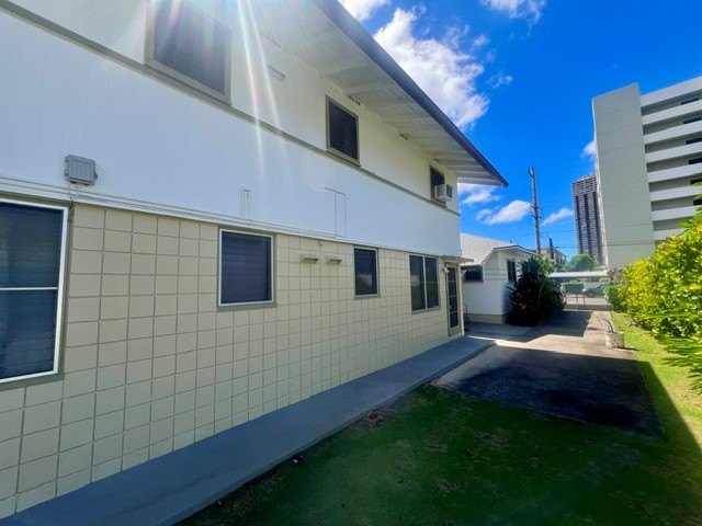 A white building with a blue sky in the background.